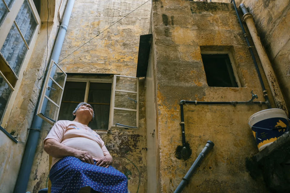 Elderly woman, sitting on a chair in the backyard, conceptual digital photography, 'Linji Sfużi' - a collection of short stories and photography